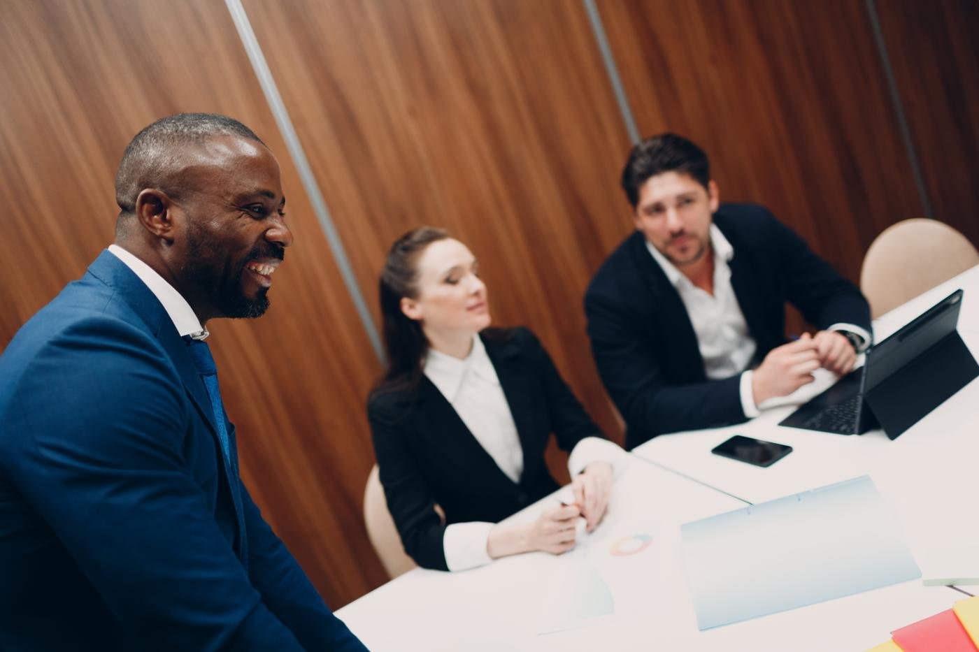 An executive sharing a moment with his team in a meeting