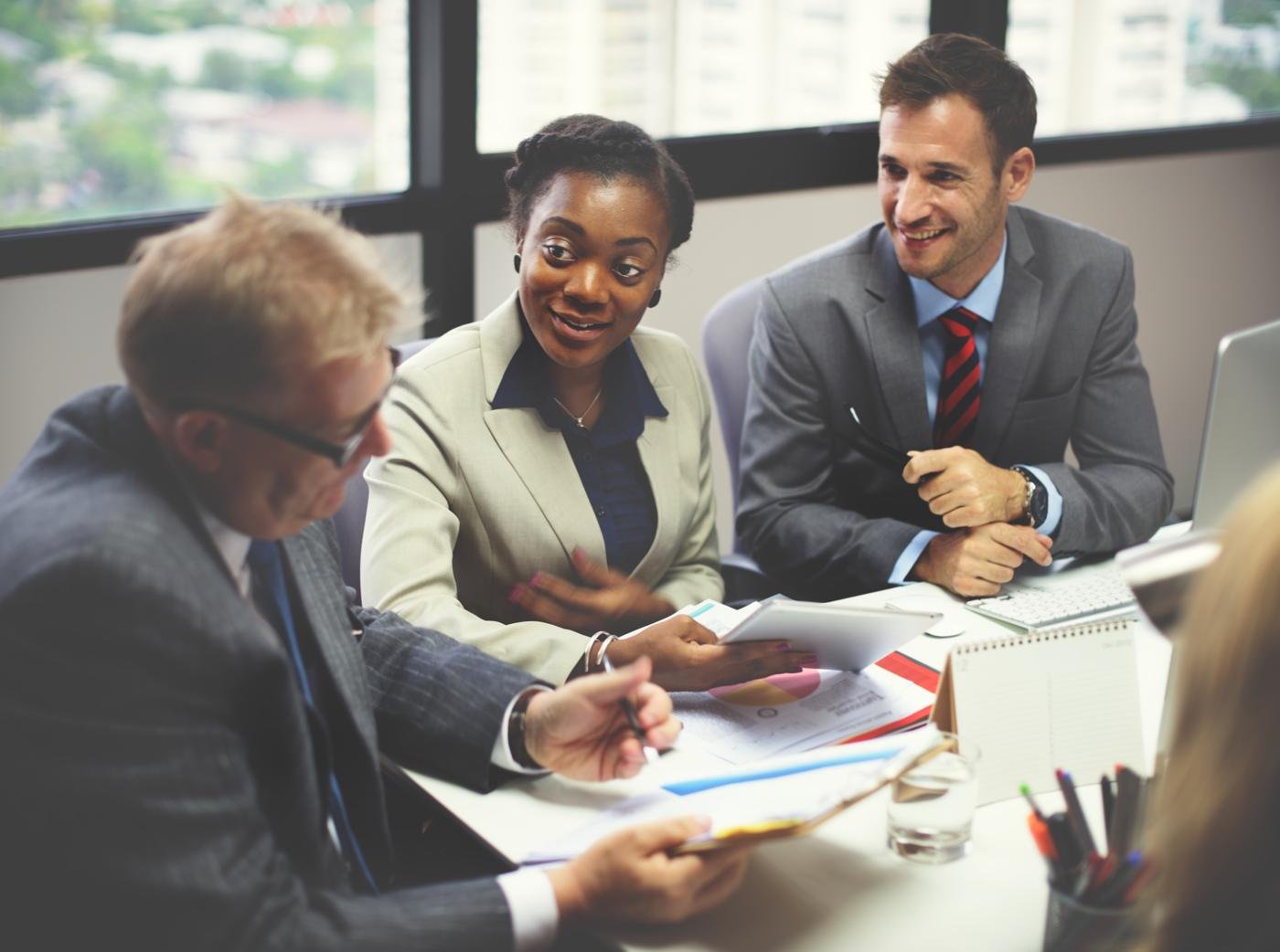 Executives in discussion around a conference table