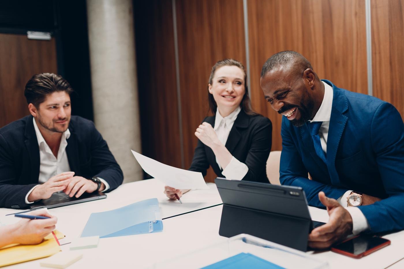 Executives reviewing a presentation on a tablet